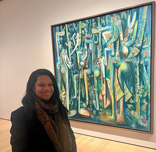 Haddassah at MOMA art museum beside a large, colorful abstract painting